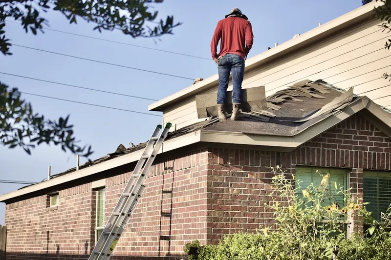 Professional roofer working on a residential roof in Camp Resolute